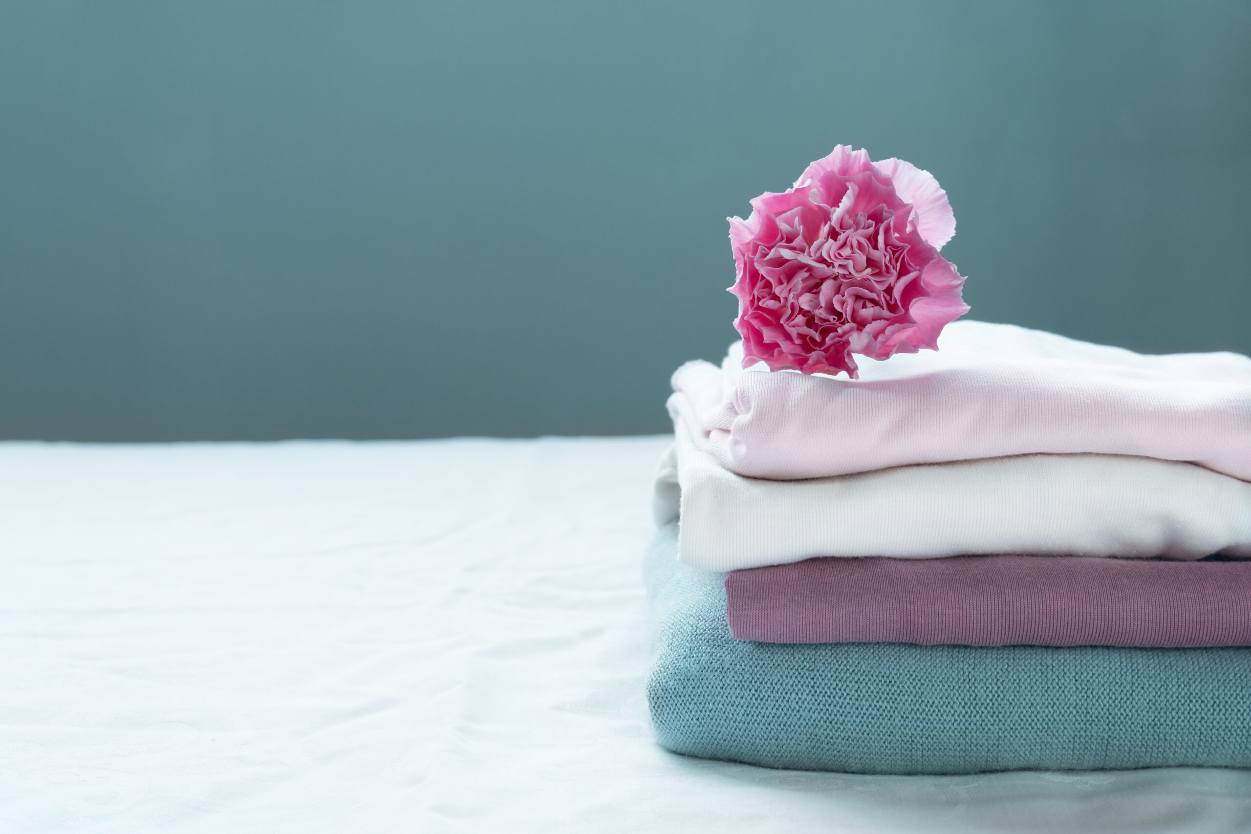 stack of clean washing pink blue cloth white with carnation flow