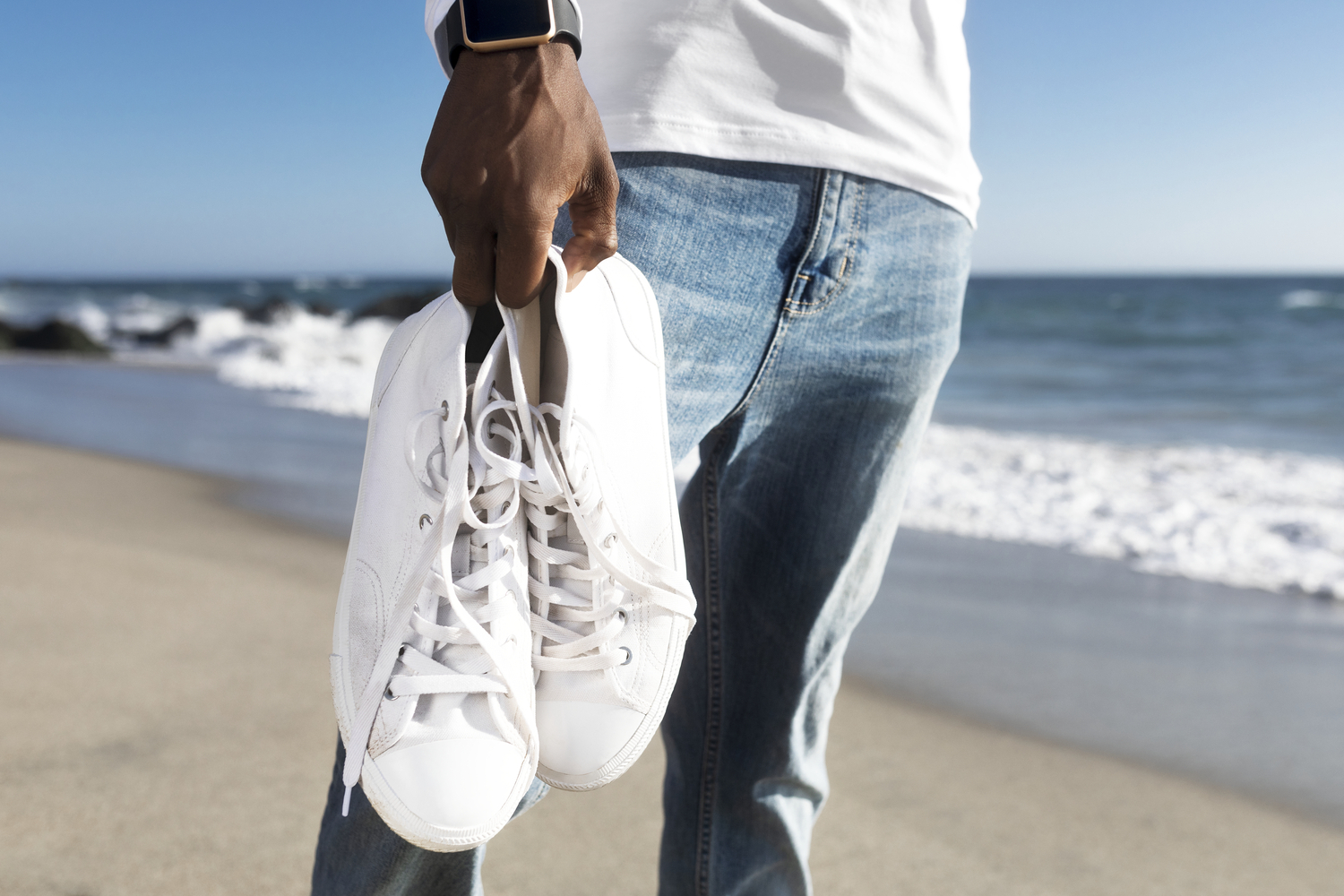 White sneakers closeup men’s apparel summer fashion beach